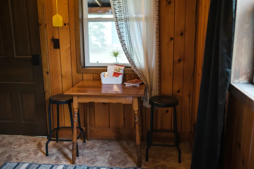 dinette table with two stools and snacks under window