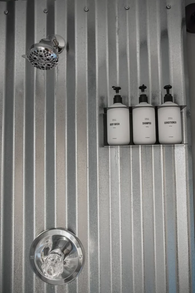 stall shower with toiletries in bathroom