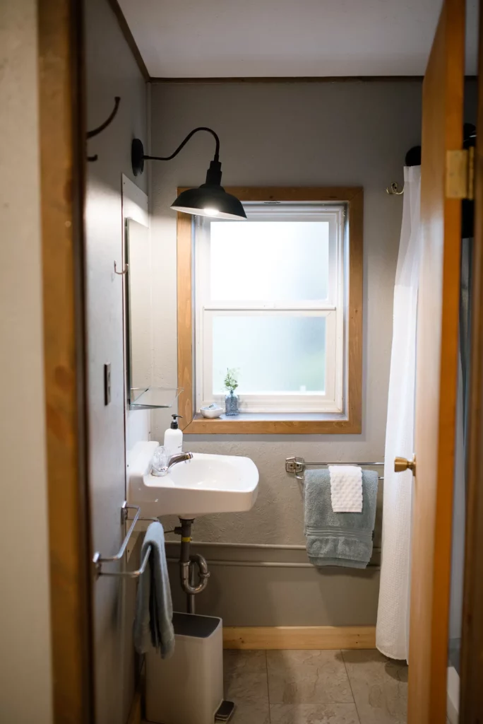 bathroom with pedestal sink, vanity and shower