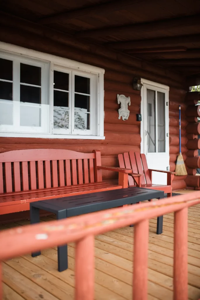 log cabin front porch with chairs and bench